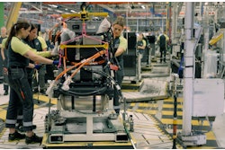 People working on a heavy-duty assembly line.