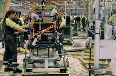 People working on a heavy-duty assembly line.