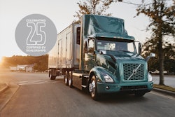 A Volvo truck on the road with a logo that says celebrating 25 certified EV dealerships.