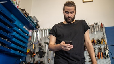 Young technician shopping for parts online
