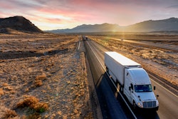 Semi truck driving on highway in desert area