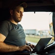 Truck driver shopping online in cab