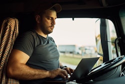 Truck driver shopping online in cab