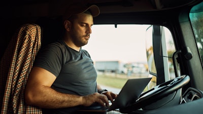 Truck driver shopping online in cab