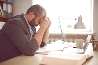 Mature man at computer frustrated