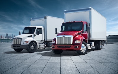 Two Peterbilt trucks parked together