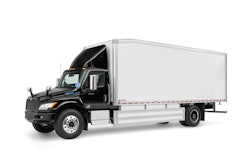 A black tractor with a white trailer.