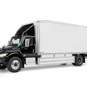 A black tractor with a white trailer.