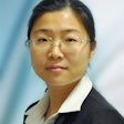 A picture of a Chinese woman wearing glasses and a suit.