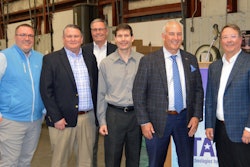 A group of men in a warehouse.