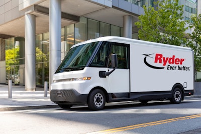 A white Ryder electric van in front of a building.