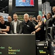 Happy people at a trade show booth.