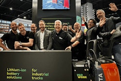 Happy people at a trade show booth.