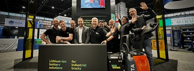 Happy people at a trade show booth.