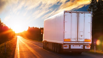 Trailer from behind on sunny highway