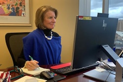 Sen. Shelley Moore Capito, R-West Virginia, sits at a desk and takes notes.