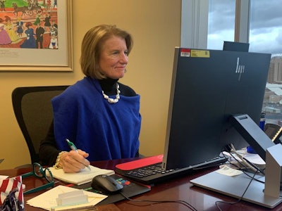 Sen. Shelley Moore Capito, R-West Virginia, sits at a desk and takes notes.