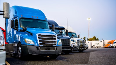 Line of trucks in row starting with blue truck