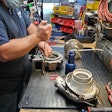 Someone works on remanufacturing a turbocharger.