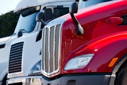 White and red trucks in a lot