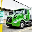 Electric truck parked next to a charging station