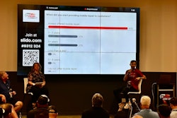 Three people sitting on stage in front of a poll.