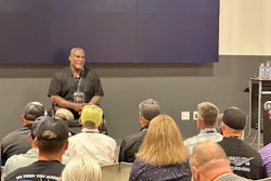 Col. Greg Gadson, a double amputee and veteran, sits in front of a room talking to business owners.