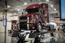 A red Mack Class 8 truck on a vehicle lift in the newly remodeled Mack Experience Center in Allentown, Pennsylvania.