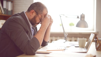 Mature man at computer frustrated.