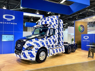 A hydrogen electric Class 8 truck from Quantron, covered in the blue-and-white Quantron logo.
