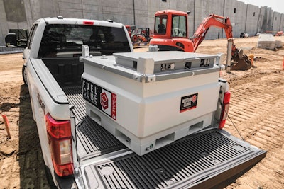 A fuel tank in the back of a pickup truck on a construction site.