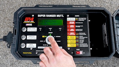 A closeup of a technician's hand as it operates an IPA diagnostic tool.