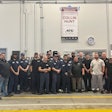 ATG's Raynham, Massachusetts, staff stands under a banner congratulating technician Collin Hunt.