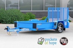 A bright blue trailer in a parking lot.