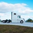 White tractor isolated against sky on highway