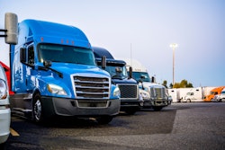 Line of trucks in row starting with blue truck