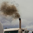 A cloud of dark exhaust floats from a truck exhaust pipe.