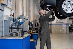 A man working in a shop with a portable cooler.