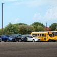 A fleet of First Student vehicles in a parking lot.