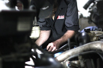 A tech working on a piece of machinery.