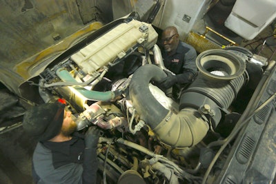 JE-CO techs work on a large piece of machinery.