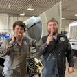 Two men eating popsicles in a garage