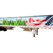 A trail king grain hopper trailer with an American flag and fields painted on it.