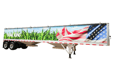 A trail king grain hopper trailer with an American flag and fields painted on it.
