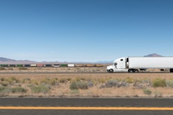 Truck drives next to train line