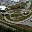 A aerial view of a large white building and several test tracks.
