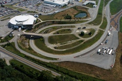 A aerial view of a large white building and several test tracks.