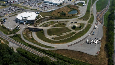 A aerial view of a large white building and several test tracks.