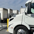 Volvo tractor being charged in a parking lot