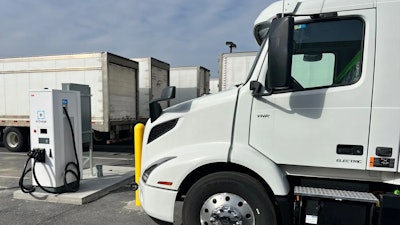 Volvo tractor being charged in a parking lot